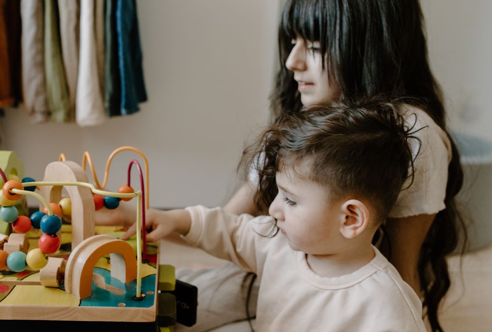 Children exploring wooden toys together